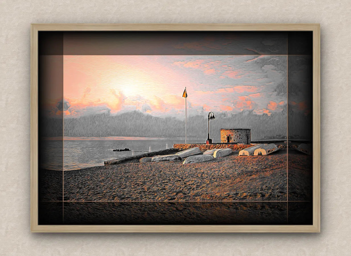 Landscape artwork of an old sea pier, tower and boats; with dark borders and oak frame, on a beige wall
