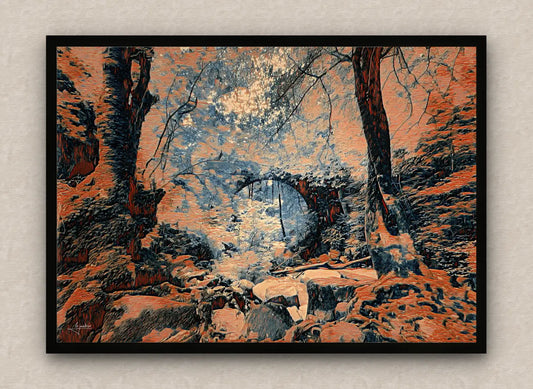 Black framed artwork in dark orange tones of an eerie forest scenery with an arch bridge over a stream.