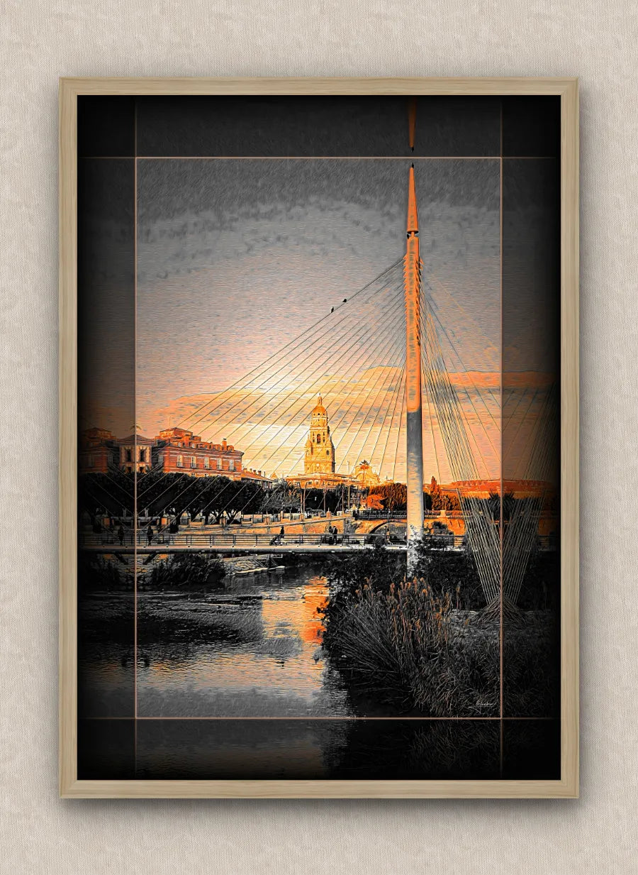 Cityscape artwork of a modern footbridge and buildings over a river during sunrise; with dark border and oak frame.