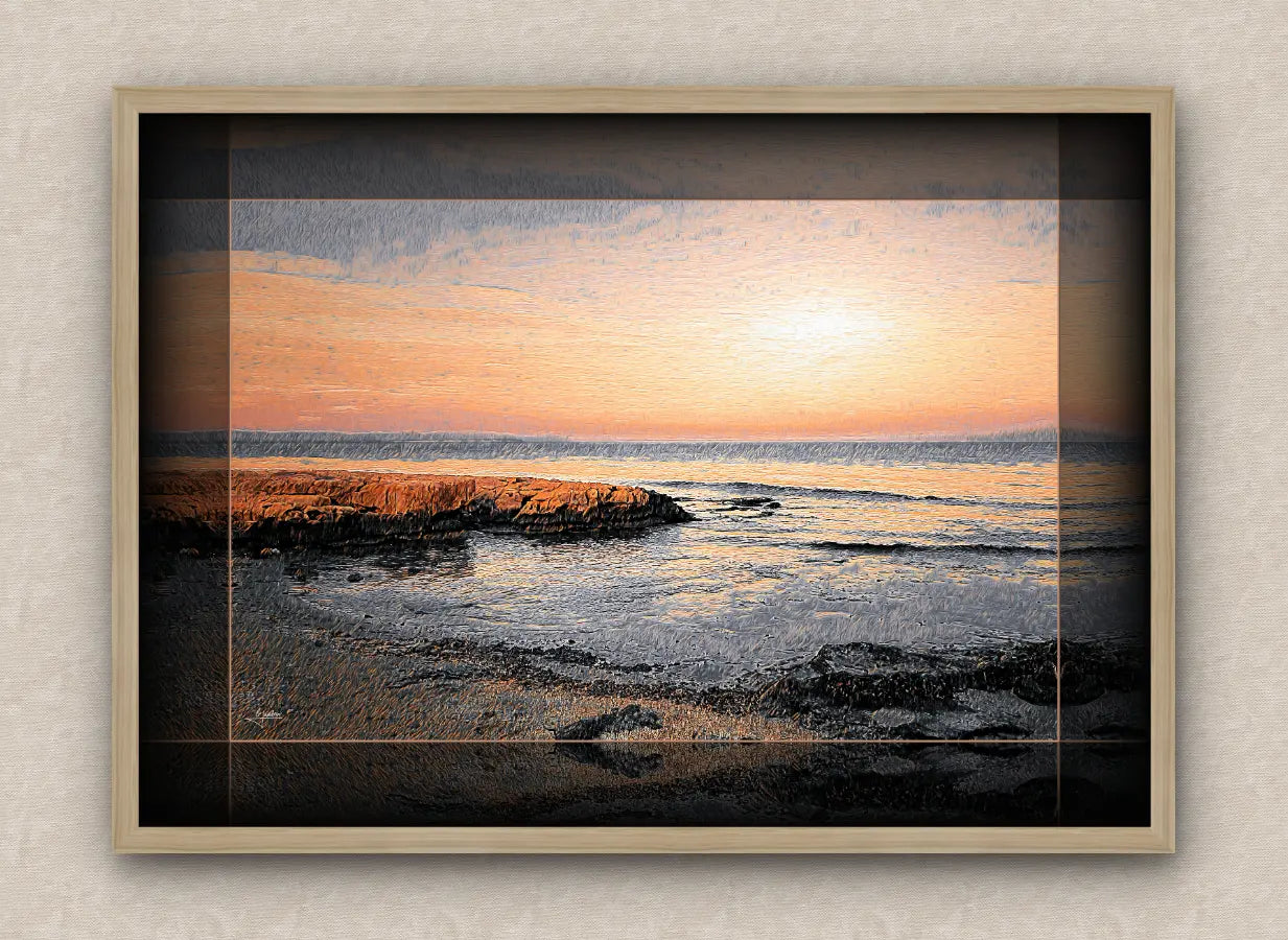 Seascape artwork of a dawn over a rocky shoreline, with black border and oak frame.