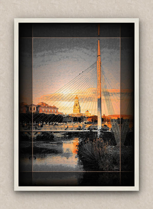 Cityscape artwork of a modern footbridge and buildings over a river during sunrise; with dark border and white frame.