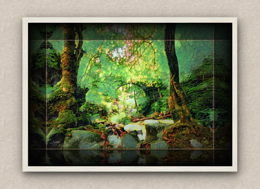 White framed wall art piece of a fantasy forest scene with an arch bridge over a stream
