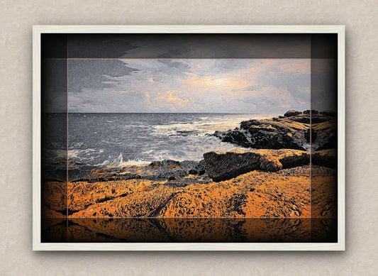 white framed artwork of a seascape with rocks and water.