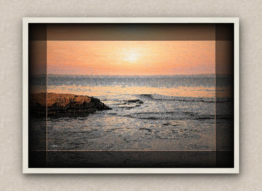 White frame artwork of a sunrise over the sea with rocks and waves in the foreground.