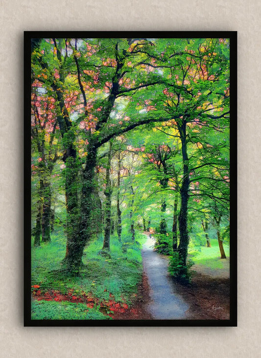 Wall artwork consisting of a landscape in portrait with a lush green forest and a path, framed in black