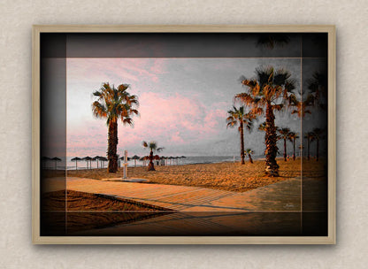 Landscape artwork of a beach and palm trees; with dark borders and oak frame, on a beige wall