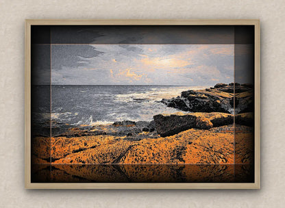 Oak framed artwork of a seascape with rocks and water.