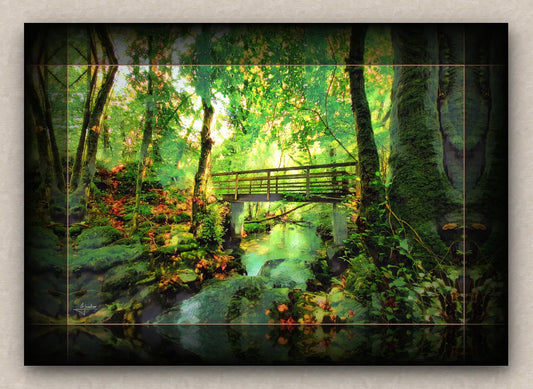 Unframed wall artwork of a lush green forest with a bridge over a stream