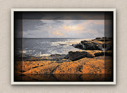 white framed artwork of a seascape with rocks and water.