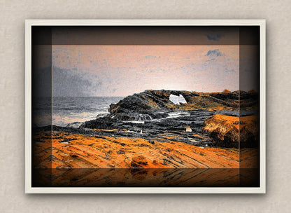 White framed artwork of a maritime landscape with rocks and ocean.