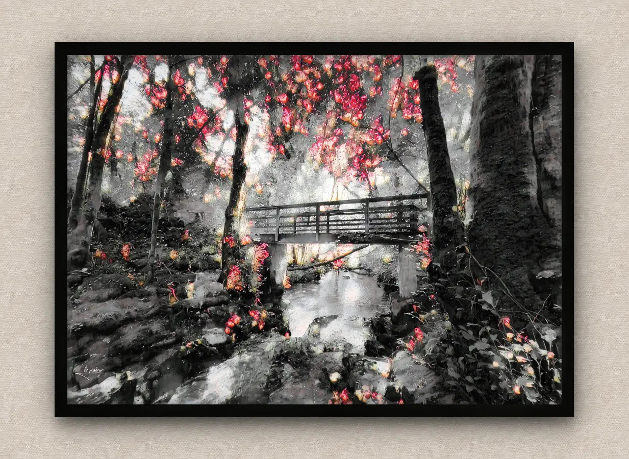 Winter scene wall art framed in black featuring a snowy forest with lush vegetation and a bridge over a stream